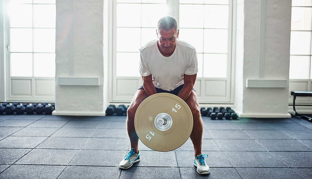 Mature man lifting weights
